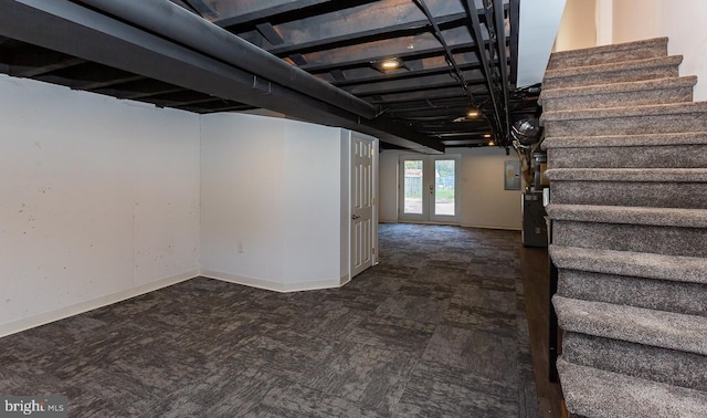 below grade area featuring carpet flooring, french doors, baseboards, stairway, and electric panel
