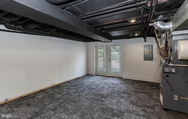 basement featuring heating unit, baseboards, electric panel, french doors, and carpet flooring