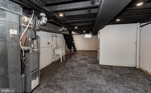 basement featuring a sink and heating unit