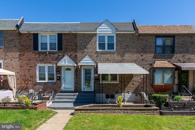 townhome / multi-family property with brick siding