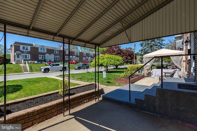 view of car parking featuring a gazebo and a residential view