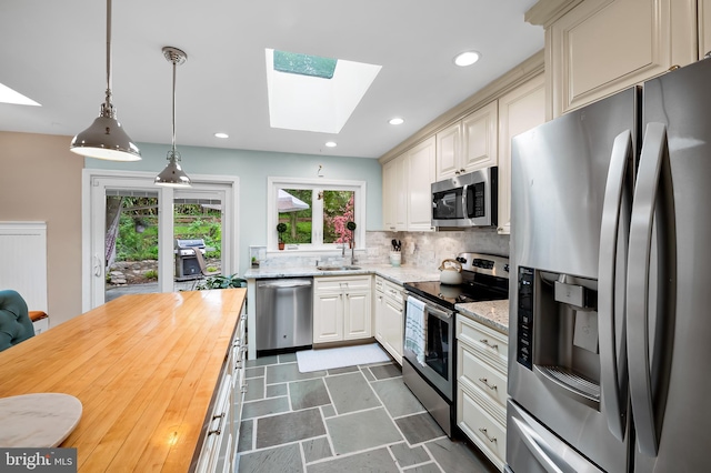 219 Gateswood Rd, Lutherville Timonium, MD 21093 - kitchen with butcher block countertops, stainless steel appliances, a skylight, and a sink