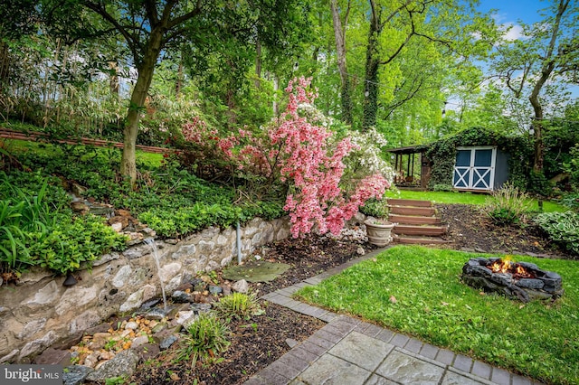 219 Gateswood Rd, Lutherville Timonium, MD 21093 - view of yard featuring an outdoor fire pit, an outdoor structure, and a storage unit