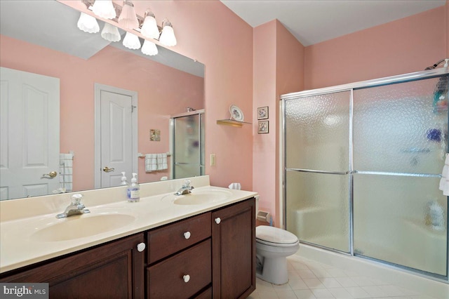 full bathroom with double vanity, a sink, and a stall shower