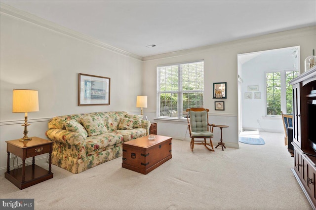 carpeted living room featuring crown molding, baseboards, and visible vents