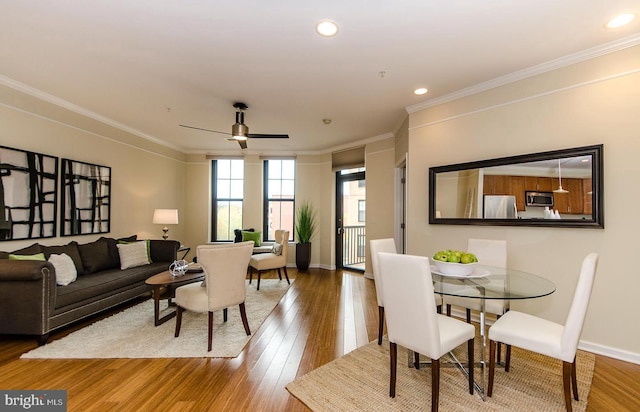 living area with crown molding, a ceiling fan, recessed lighting, and wood finished floors