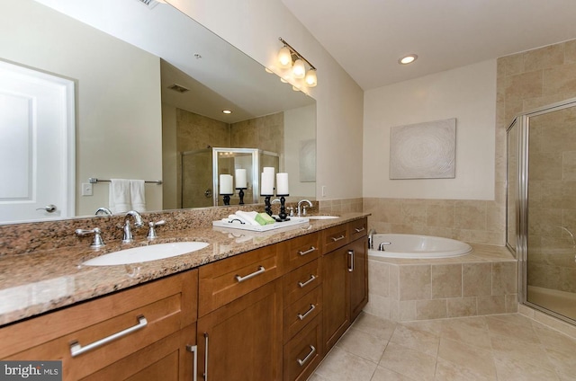 full bath featuring tile patterned flooring, a sink, a garden tub, and a stall shower