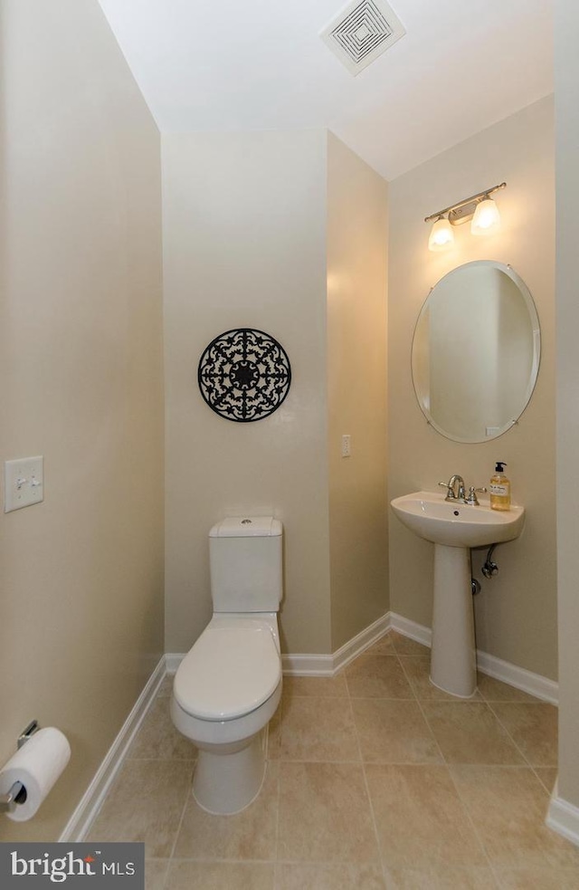 bathroom with visible vents, baseboards, tile patterned flooring, and toilet
