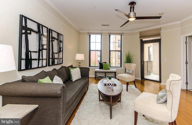 living area with visible vents, wood finished floors, and a wealth of natural light