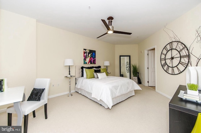 bedroom with light colored carpet, baseboards, and ceiling fan