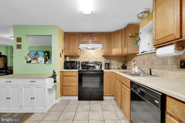 1112 Conservation Dr, Hedgesville, WV 25427 - kitchen featuring black appliances, under cabinet range hood, a sink, light countertops, and a textured ceiling