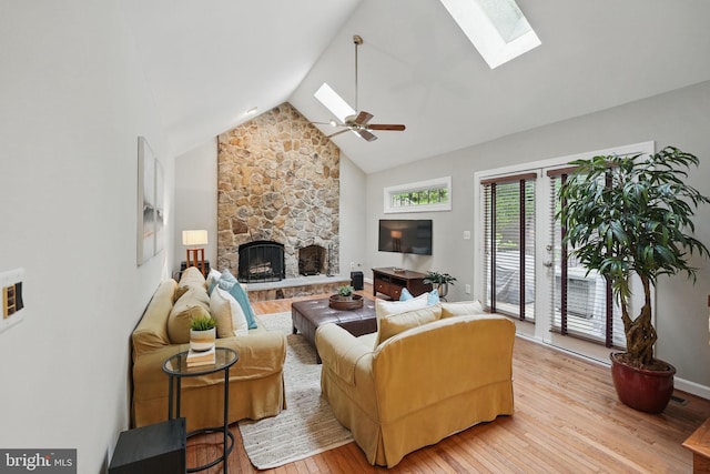 1253 Rowland Dr, Herndon, VA 20170 - living area featuring a skylight, wood finished floors, a stone fireplace, a ceiling fan, and high vaulted ceiling