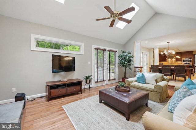 1253 Rowland Dr, Herndon, VA 20170 - living room with light wood-style flooring, a chandelier, high vaulted ceiling, ceiling fan, and a skylight