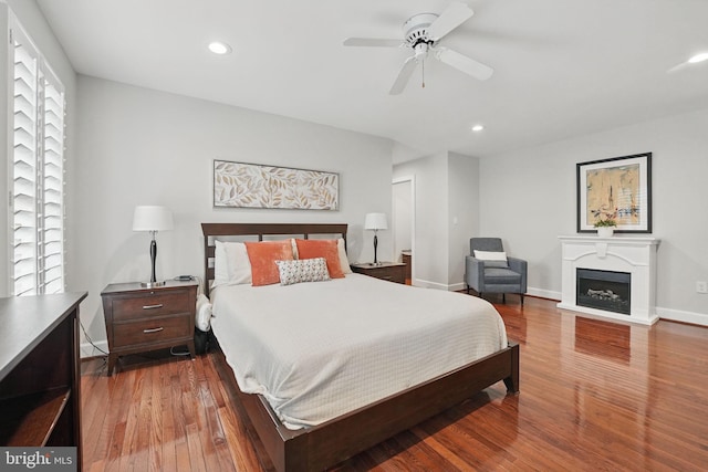 1253 Rowland Dr, Herndon, VA 20170 - bedroom featuring wood finished floors, recessed lighting, baseboards, a fireplace, and a ceiling fan
