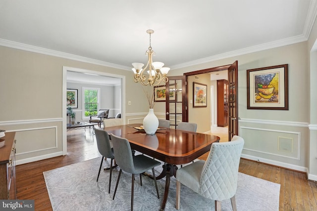 1253 Rowland Dr, Herndon, VA 20170 - dining space with crown molding, a chandelier, and wood finished floors