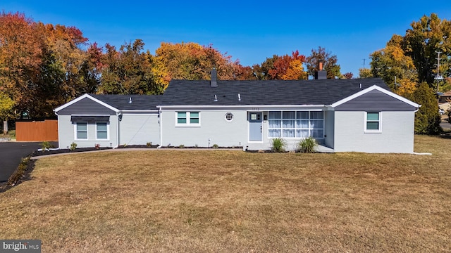 ranch-style home with a front lawn and brick siding