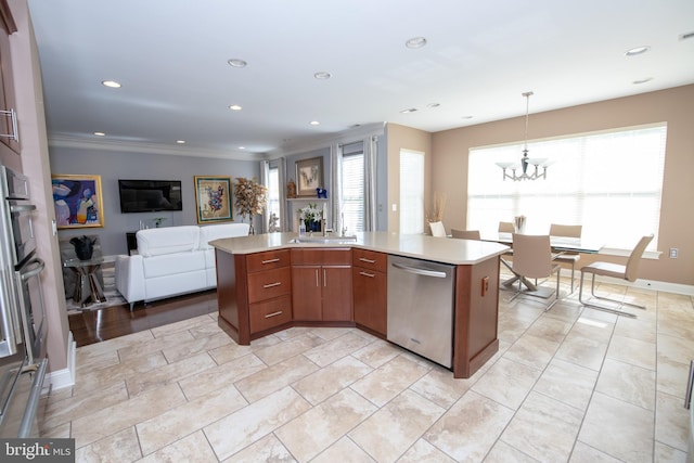 kitchen featuring light countertops, appliances with stainless steel finishes, an inviting chandelier, and open floor plan