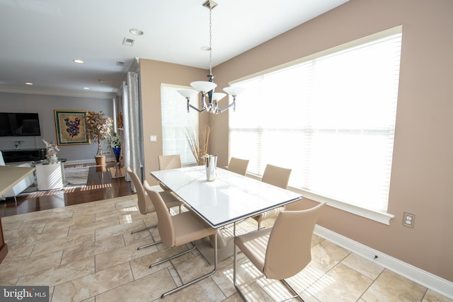 dining room with baseboards, an inviting chandelier, and a wealth of natural light