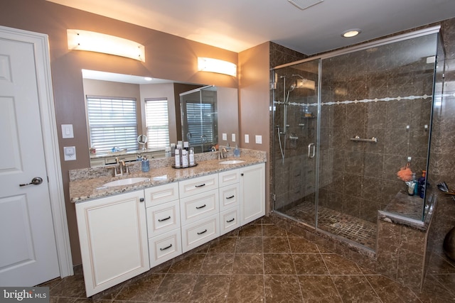 full bath with a sink and a shower stall