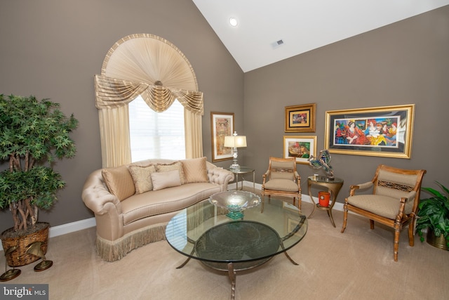 carpeted living room with baseboards, visible vents, and high vaulted ceiling