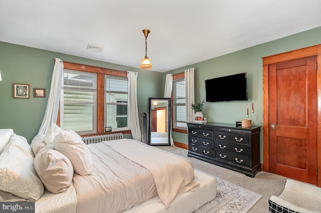 bedroom featuring visible vents and light carpet