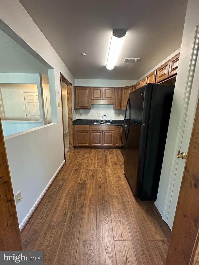 1 Warthens Way Unit H, Emmitsburg, MD 21727 - kitchen featuring freestanding refrigerator, a sink, dark wood-style flooring, dark countertops, and baseboards