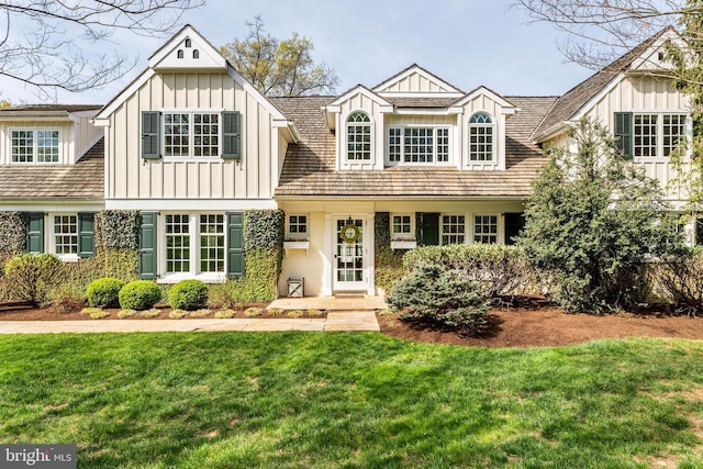 view of front facade featuring board and batten siding and a front lawn