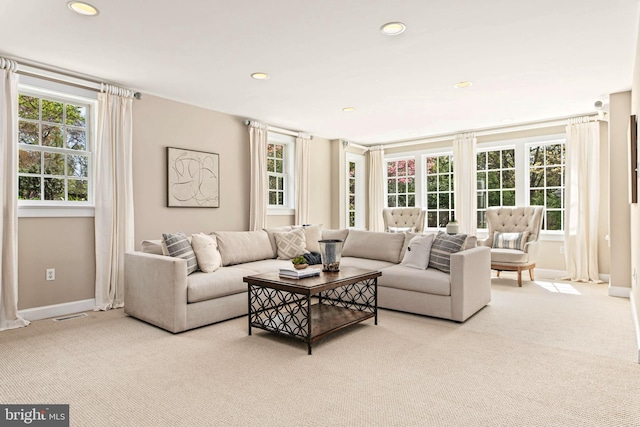 carpeted living room with baseboards, recessed lighting, and visible vents