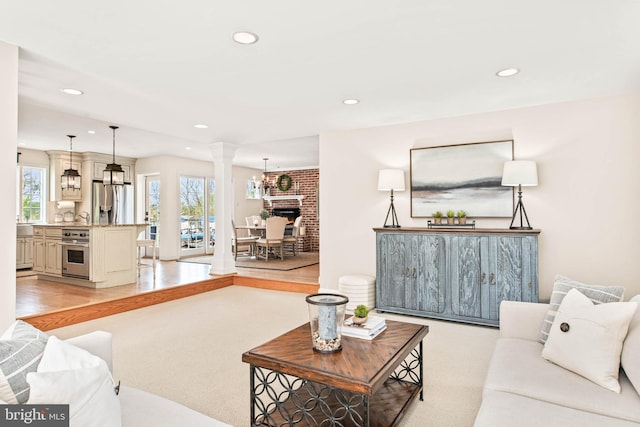 living room with decorative columns and recessed lighting