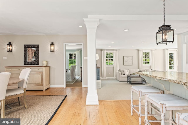 dining space with recessed lighting, light wood-style flooring, and baseboards