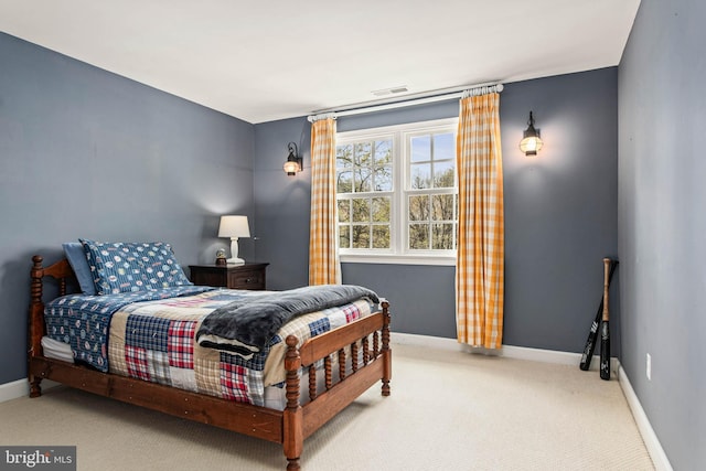 carpeted bedroom featuring baseboards