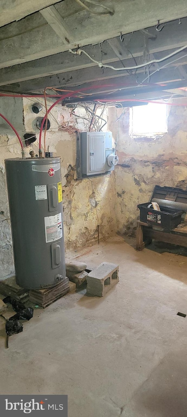 below grade area featuring electric panel and electric water heater