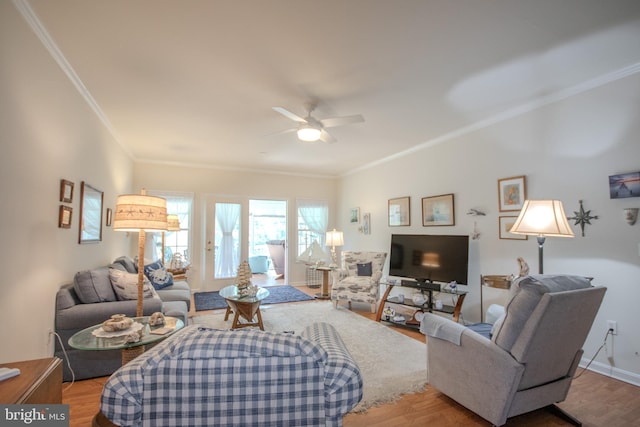 living room featuring crown molding, ceiling fan, and wood finished floors