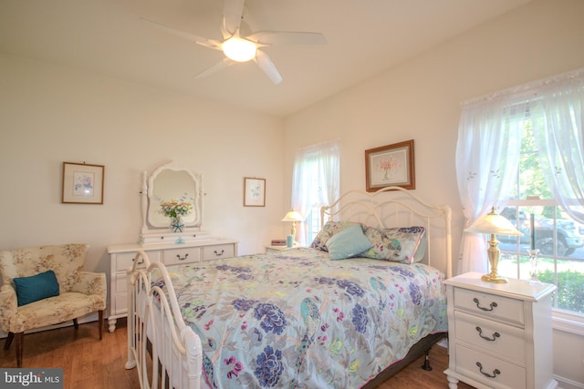 bedroom with a ceiling fan and wood finished floors