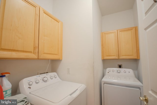 laundry room featuring washing machine and dryer and cabinet space