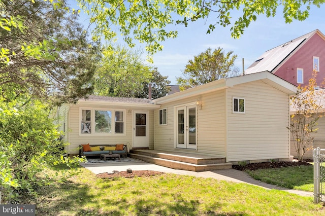 back of property with a lawn, outdoor lounge area, a patio area, and french doors