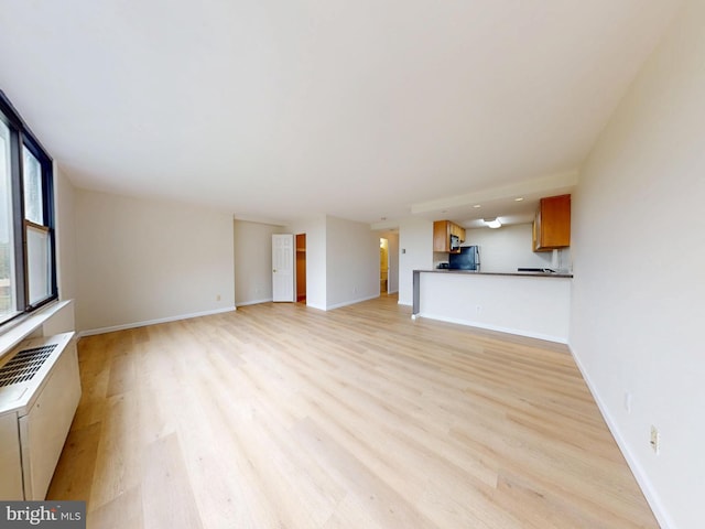 4600 Duke St Unit 1018, Alexandria, VA 22304 - unfurnished living room featuring light wood-type flooring and baseboards
