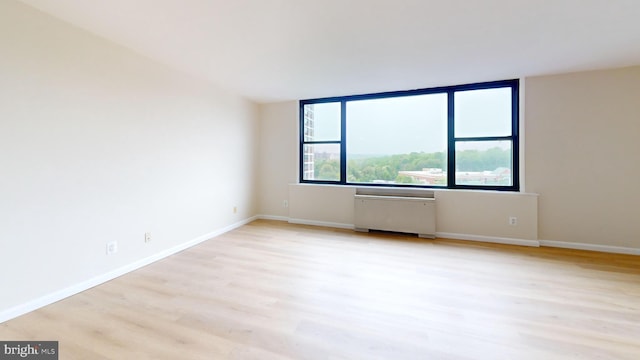 4600 Duke St Unit 1018, Alexandria, VA 22304 - spare room featuring light wood-style floors, radiator heating unit, and baseboards