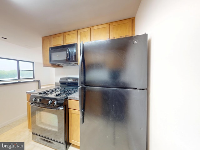 4600 Duke St Unit 1018, Alexandria, VA 22304 - kitchen with light brown cabinetry, baseboards, and black appliances