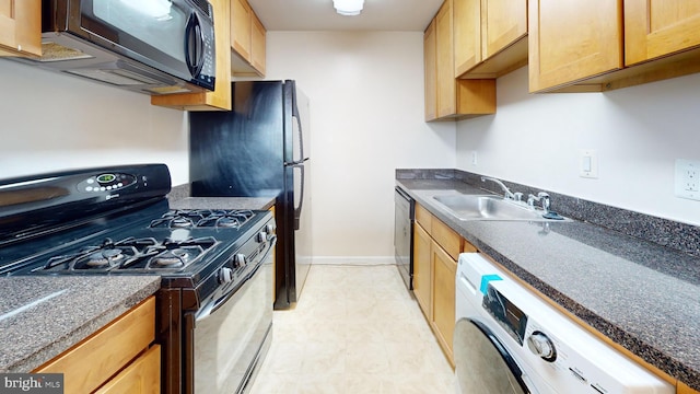 4600 Duke St Unit 1018, Alexandria, VA 22304 - kitchen with dark countertops, a sink, washer / clothes dryer, baseboards, and black appliances