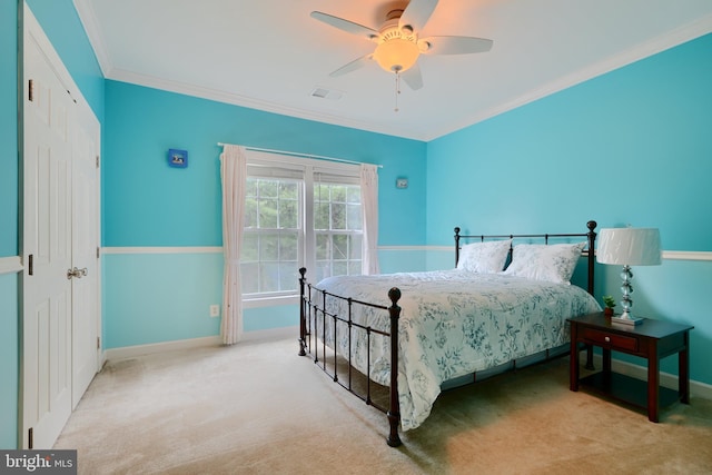 bedroom with baseboards, carpet floors, ornamental molding, and a ceiling fan