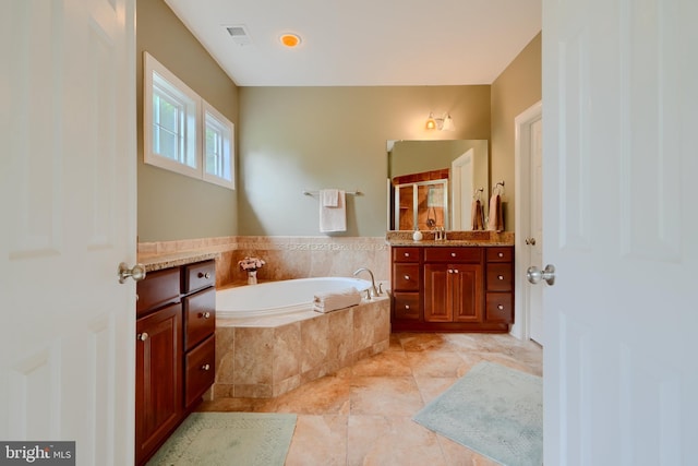 full bathroom featuring a bath, vanity, and a stall shower