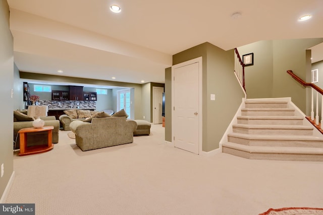 living area featuring bar area, stairway, recessed lighting, baseboards, and carpet