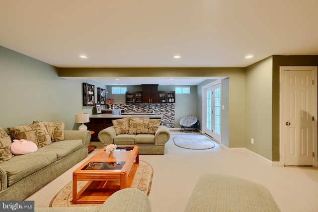 living area featuring bar, light colored carpet, and recessed lighting