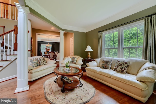 living room featuring ornate columns, light wood-style flooring, ornamental molding, stairway, and recessed lighting