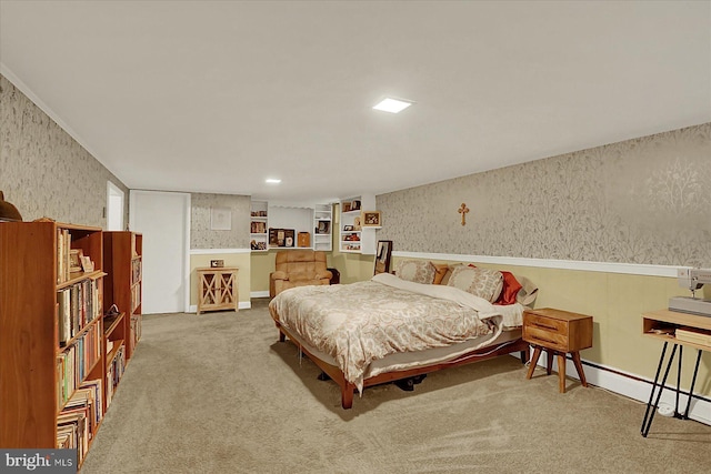 bedroom with wallpapered walls and carpet floors