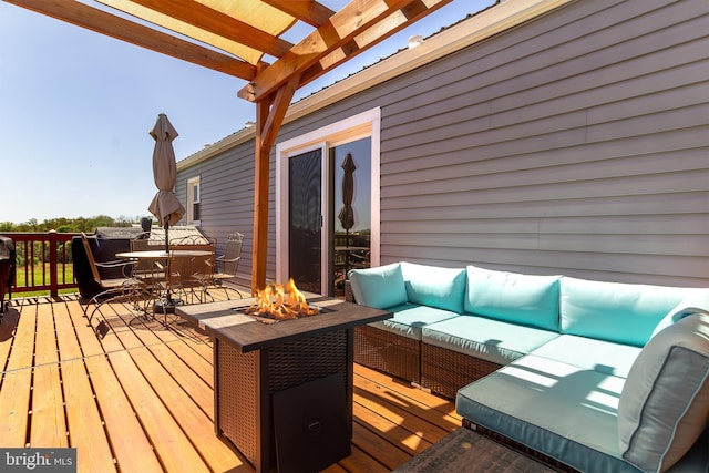wooden terrace with an outdoor living space with a fire pit, a pergola, and outdoor dining space