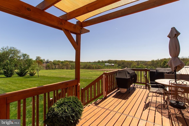 deck featuring a pergola, area for grilling, and a lawn