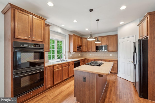 6 Crawford Ln, Stafford, VA 22556 - kitchen with a sink, light countertops, light wood-style floors, and black appliances