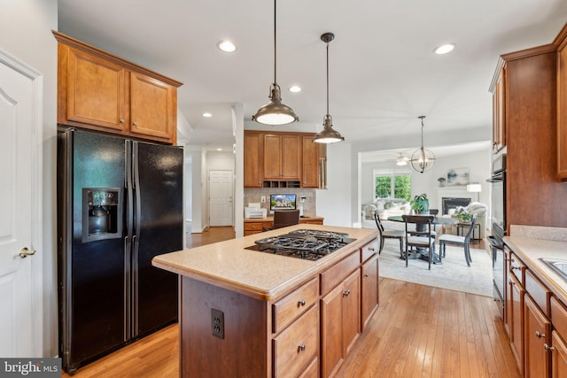 6 Crawford Ln, Stafford, VA 22556 - kitchen featuring light countertops, a kitchen island, black appliances, and brown cabinets
